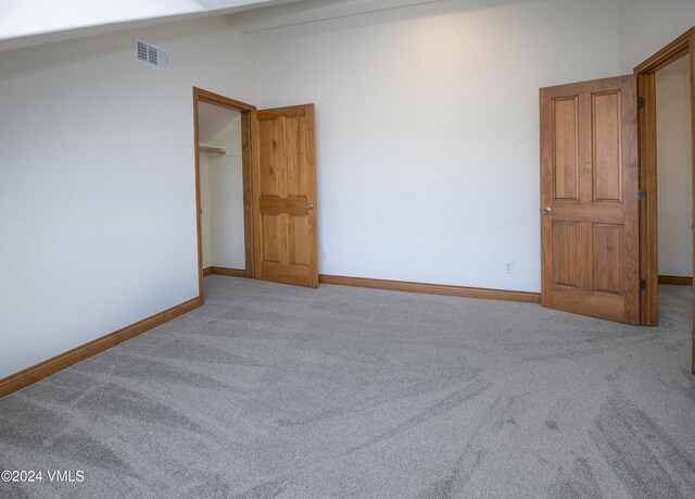 49 Bluffs Dr, Eagle, CO 81631 - spare room with vaulted ceiling and carpet flooring
