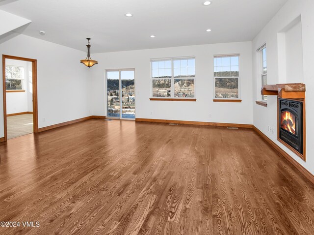 49 Bluffs Dr, Eagle, CO 81631 - unfurnished living room featuring wood-type flooring
