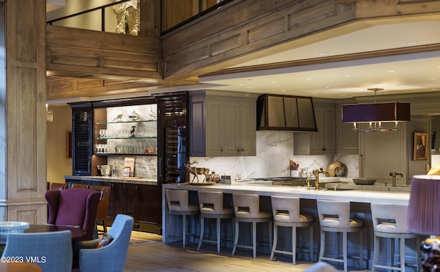 17 Chateau Ln Unit 501, Beaver Creek, CO 81620 - community bar area with wall chimney exhaust hood, decorative backsplash, wood finished floors, and pendant lighting