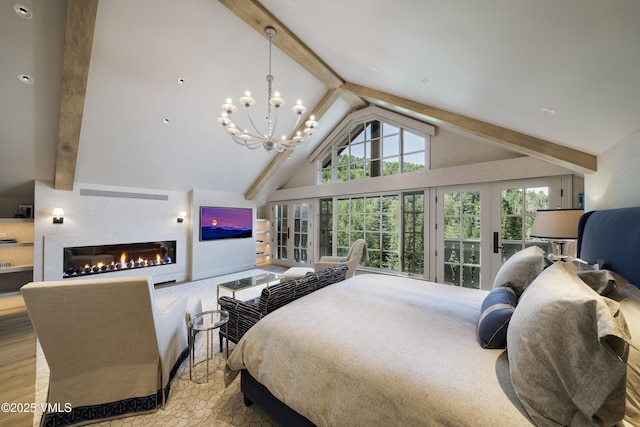 17 Chateau Ln Unit 501, Beaver Creek, CO 81620 - bedroom featuring french doors, a glass covered fireplace, wood finished floors, and a chandelier