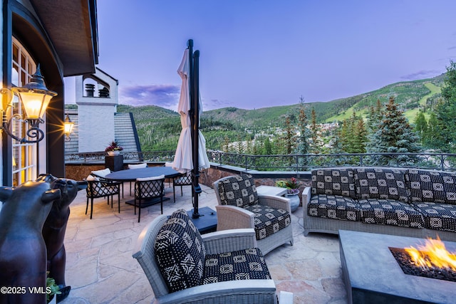 17 Chateau Ln Unit 501, Beaver Creek, CO 81620 - view of patio / terrace featuring an outdoor living space with a fire pit, outdoor dining area, and a mountain view