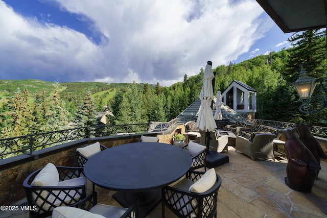 17 Chateau Ln Unit 501, Beaver Creek, CO 81620 - view of patio with a wooded view and outdoor dining space