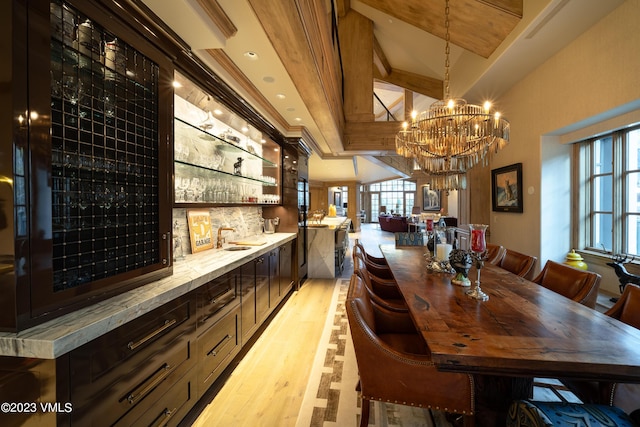 17 Chateau Ln Unit 501, Beaver Creek, CO 81620 - dining room with light wood finished floors, beamed ceiling, a chandelier, and a community bar