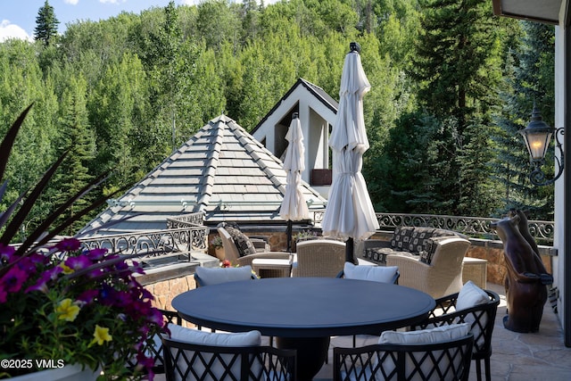 17 Chateau Ln Unit 501, Beaver Creek, CO 81620 - view of patio / terrace featuring outdoor dining space and a wooded view