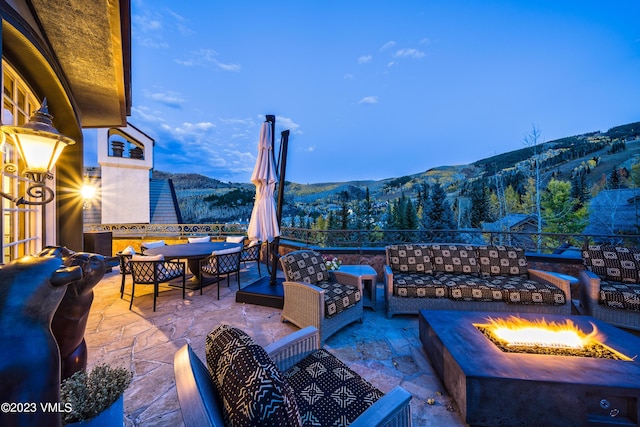 17 Chateau Ln Unit 501, Beaver Creek, CO 81620 - view of patio featuring a mountain view, an outdoor living space with a fire pit, and outdoor dining area