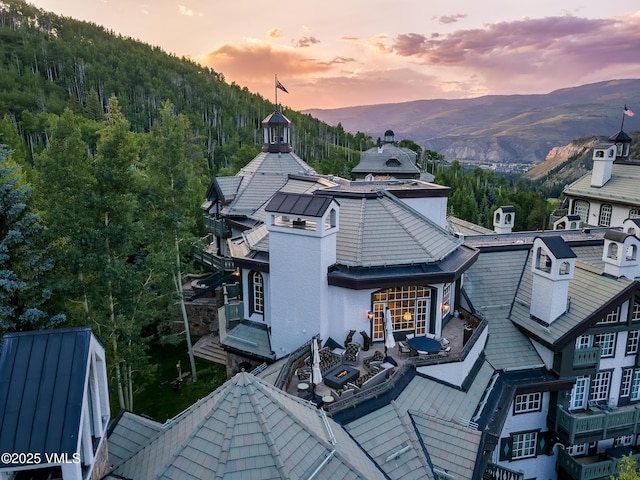 17 Chateau Ln Unit 501, Beaver Creek, CO 81620 - back of house at dusk featuring a mountain view and stucco siding