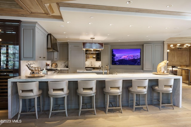 17 Chateau Ln Unit 501, Beaver Creek, CO 81620 - kitchen featuring gray cabinetry, a peninsula, custom range hood, backsplash, and recessed lighting