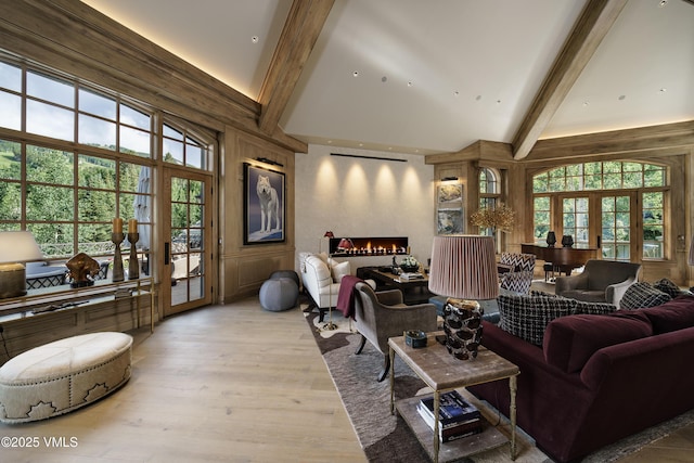 17 Chateau Ln Unit 501, Beaver Creek, CO 81620 - living area featuring high vaulted ceiling, beam ceiling, a large fireplace, and wood finished floors