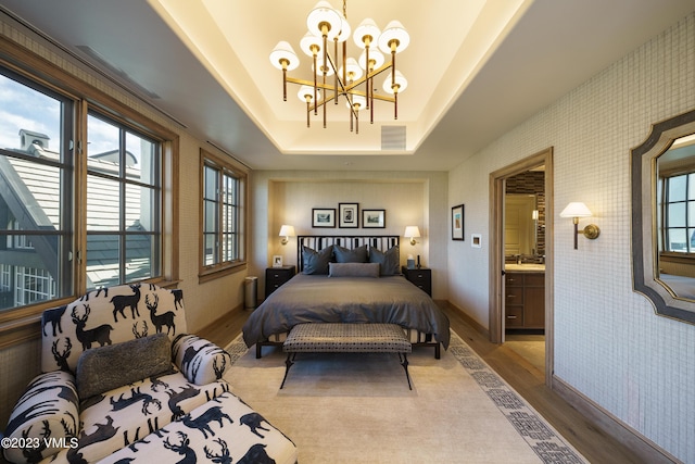 17 Chateau Ln Unit 501, Beaver Creek, CO 81620 - bedroom with wood finished floors, a chandelier, multiple windows, and wallpapered walls