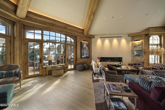17 Chateau Ln Unit 501, Beaver Creek, CO 81620 - living room featuring high vaulted ceiling, beamed ceiling, wood finished floors, a water view, and a high end fireplace