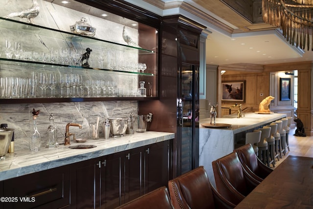 17 Chateau Ln Unit 501, Beaver Creek, CO 81620 - indoor wet bar with backsplash, ornamental molding, and wood finished floors