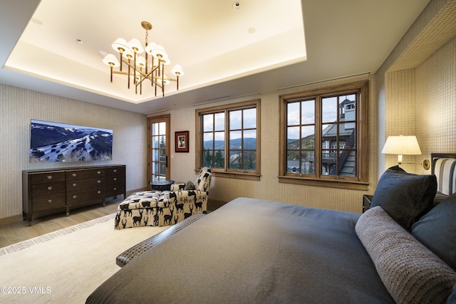 17 Chateau Ln Unit 501, Beaver Creek, CO 81620 - bedroom featuring wood finished floors, wallpapered walls, a chandelier, and a raised ceiling