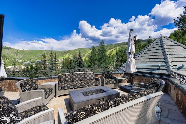 17 Chateau Ln Unit 501, Beaver Creek, CO 81620 - view of patio / terrace with an outdoor living space with a fire pit and a mountain view