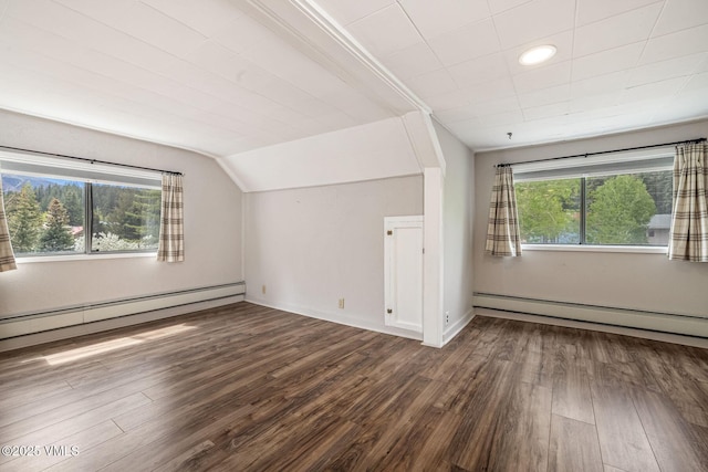 562 Main St, Minturn, CO 81645 - additional living space with baseboard heating, dark wood-style floors, a baseboard radiator, vaulted ceiling, and baseboards