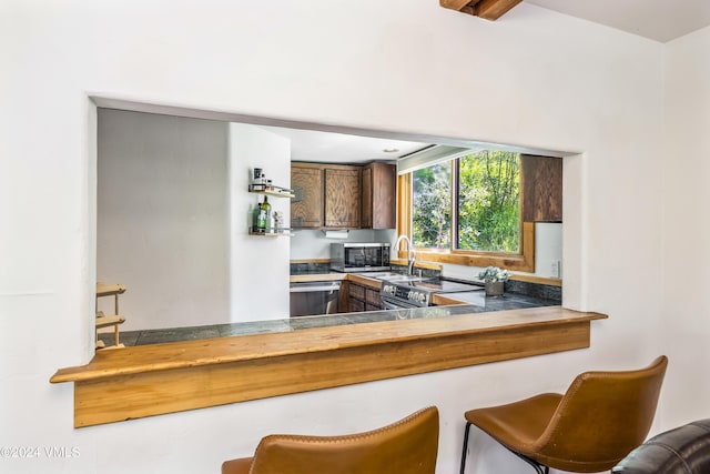 kitchen with stainless steel appliances, sink, and kitchen peninsula