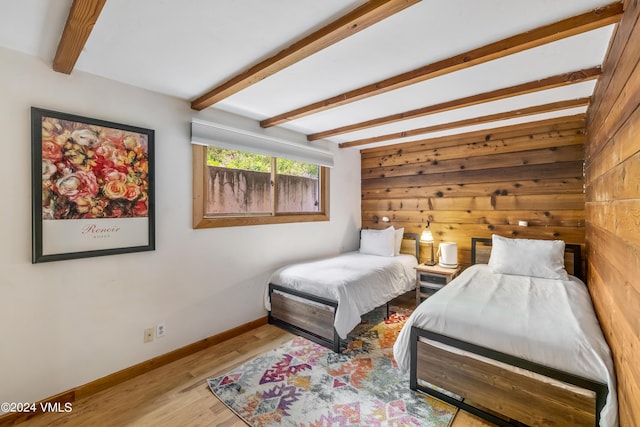 2963 Bellflower Dr, Vail, CO 81657 - bedroom featuring wooden walls, beam ceiling, and light hardwood / wood-style floors