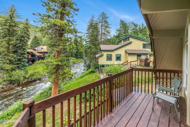 wooden terrace featuring a water view