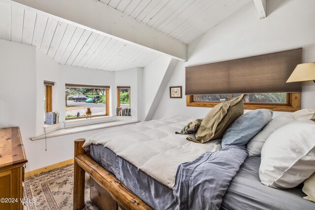 bedroom featuring wood ceiling and lofted ceiling with beams