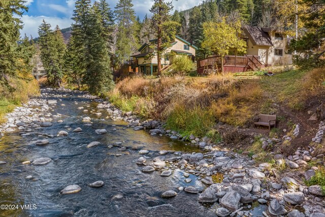 2963 Bellflower Dr, Vail, CO 81657 - view of yard featuring a deck with water view