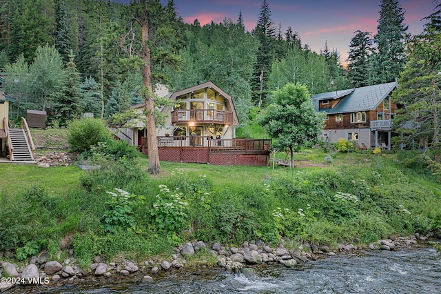 2963 Bellflower Dr, Vail, CO 81657 - yard at dusk with a wooden deck and a sunroom