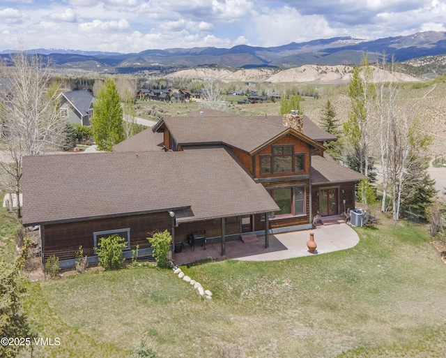0017 Harvester Ct, Eagle, CO 81631 - rear view of house featuring a patio, roof with shingles, a chimney, and a mountain view