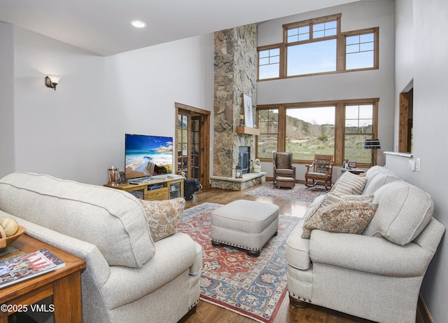 0017 Harvester Ct, Eagle, CO 81631 - living area with wood finished floors, a fireplace, a high ceiling, and recessed lighting