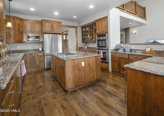 0017 Harvester Ct, Eagle, CO 81631 - kitchen featuring a sink, appliances with stainless steel finishes, dark wood finished floors, a kitchen island with sink, and stone countertops