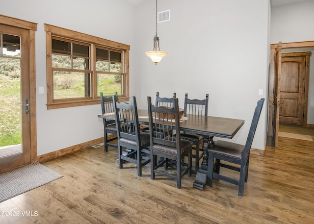 0017 Harvester Ct, Eagle, CO 81631 - dining space with wood finished floors, high vaulted ceiling, and baseboards