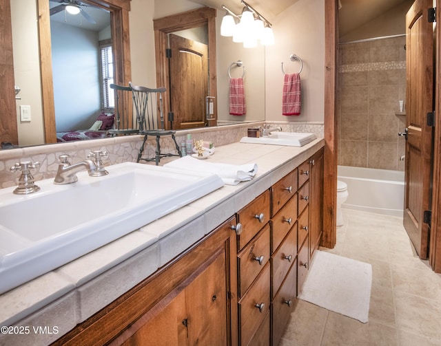 0017 Harvester Ct, Eagle, CO 81631 - bathroom with tile patterned floors, toilet, double vanity, a ceiling fan, and bathing tub / shower combination
