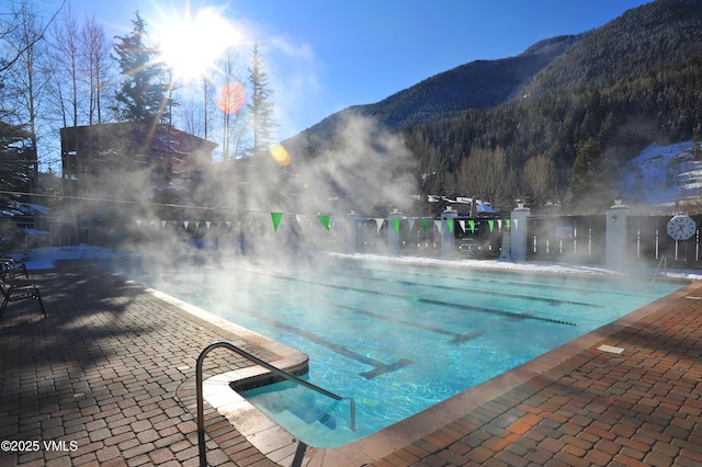 pool with a mountain view and a patio