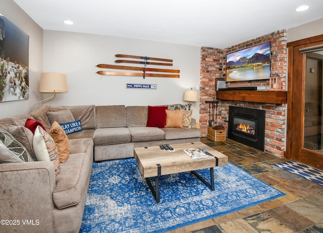 living room with recessed lighting and a brick fireplace