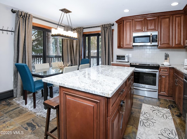 kitchen with light stone countertops, stone tile floors, decorative backsplash, a kitchen breakfast bar, and stainless steel appliances