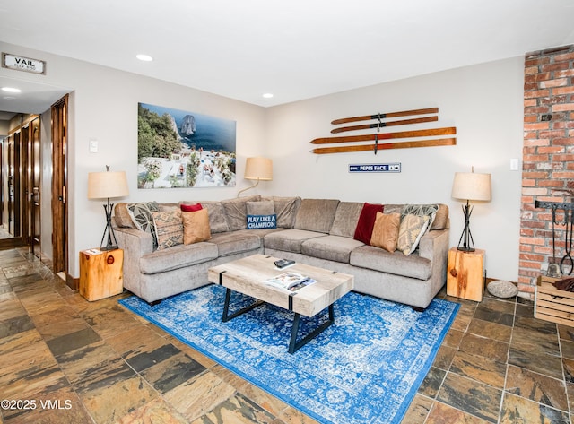 living area with recessed lighting and stone tile flooring