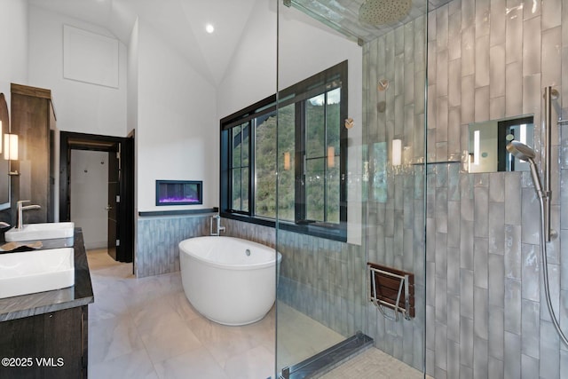 420 Little Andorra Rd, Edwards, CO 81632 - bathroom with a tile shower, tile walls, a soaking tub, double vanity, and a wainscoted wall