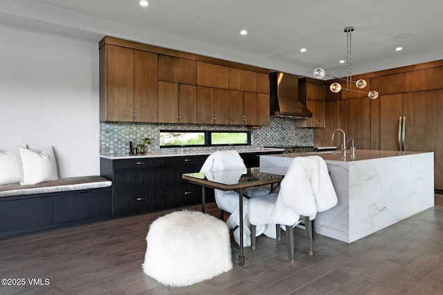 420 Little Andorra Rd, Edwards, CO 81632 - kitchen featuring wall chimney exhaust hood, decorative backsplash, dark wood-type flooring, recessed lighting, and pendant lighting