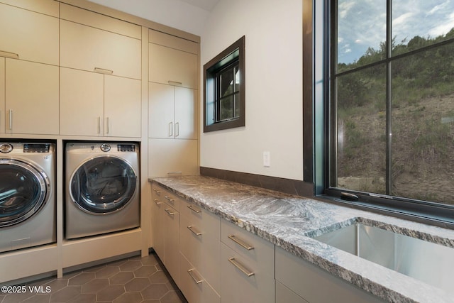 420 Little Andorra Rd, Edwards, CO 81632 - laundry area with cabinet space, washer and dryer, and dark tile patterned flooring
