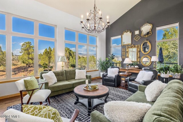 sunroom / solarium featuring a chandelier