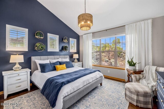 bedroom featuring vaulted ceiling and wood-type flooring