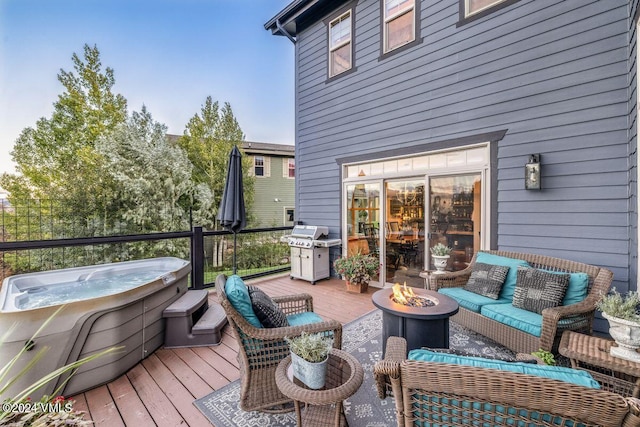 wooden terrace featuring a hot tub, area for grilling, and an outdoor living space with a fire pit