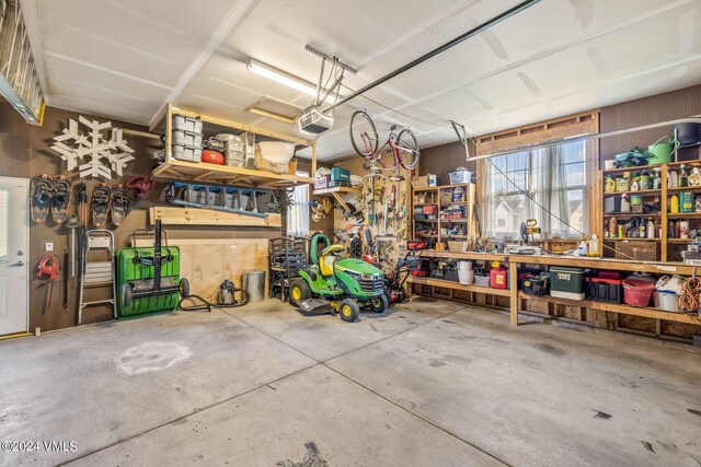 garage featuring a garage door opener and a workshop area