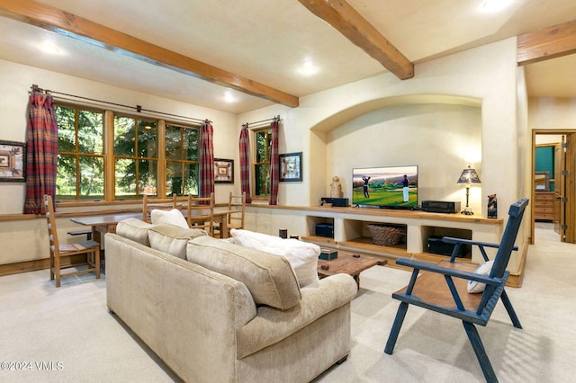 living room featuring beam ceiling and light colored carpet