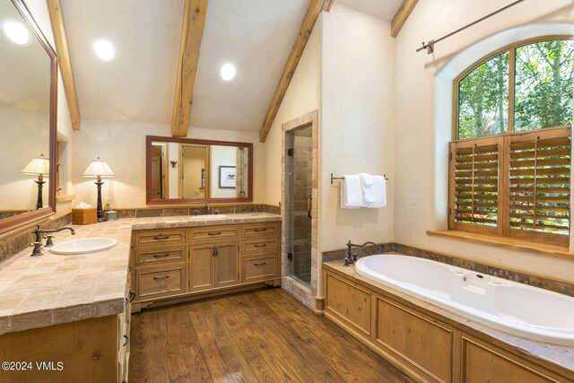 bathroom with vanity, wood-type flooring, lofted ceiling with beams, and shower with separate bathtub