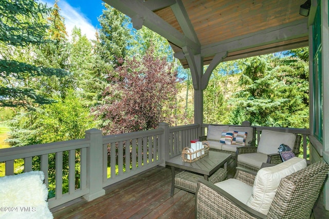 wooden terrace featuring an outdoor living space