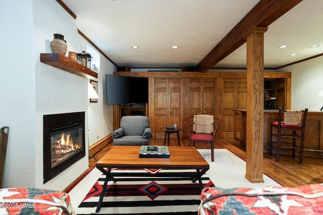 2111 Vermont Rd Unit A, Vail, CO 81657 - living area with wood finished floors, ornamental molding, a glass covered fireplace, and recessed lighting