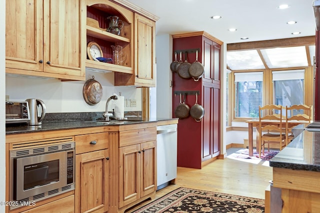 2111 Vermont Rd Unit A, Vail, CO 81657 - kitchen featuring stainless steel microwave, dishwashing machine, light wood-style floors, dark stone countertops, and recessed lighting