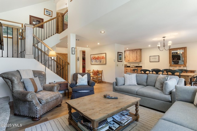 2111 Vermont Rd Unit A, Vail, CO 81657 - living room featuring light wood-style floors, a chandelier, recessed lighting, stairway, and a towering ceiling
