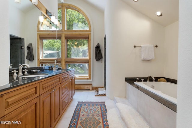 2111 Vermont Rd Unit A, Vail, CO 81657 - bathroom featuring plenty of natural light, a bath, tile patterned flooring, double vanity, and high vaulted ceiling