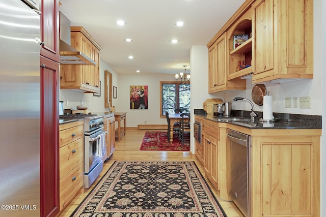 2111 Vermont Rd Unit A, Vail, CO 81657 - kitchen with stainless steel appliances, wall chimney exhaust hood, recessed lighting, a chandelier, and light wood-type flooring