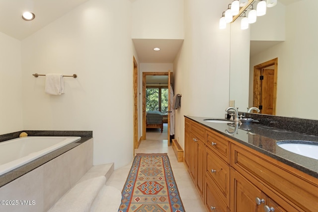 2111 Vermont Rd Unit A, Vail, CO 81657 - ensuite bathroom featuring a garden tub, double vanity, tile patterned floors, and recessed lighting