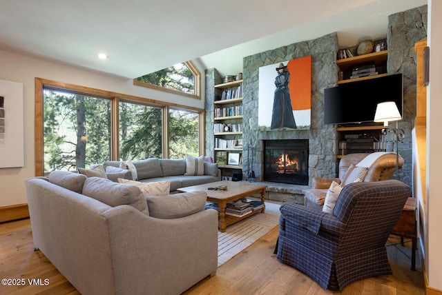 2111 Vermont Rd Unit A, Vail, CO 81657 - living room with light wood-type flooring, a stone fireplace, built in features, lofted ceiling, and recessed lighting